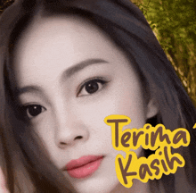 a close up of a woman 's face with the words terima kasih written on it
