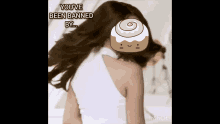 a picture of a woman with a cinnamon roll on her head