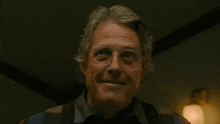 an older man wearing glasses and a striped shirt