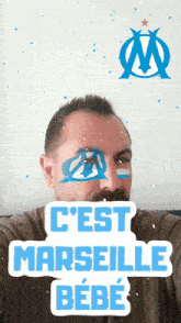 a man taking a selfie with a sticker that says c'est marseille bebe on it