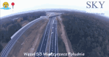 an aerial view of a highway with the words sky above