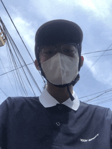 a man wearing a helmet and a mask has a shirt that says yody sport on it