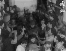 a large group of people are gathered in a room .
