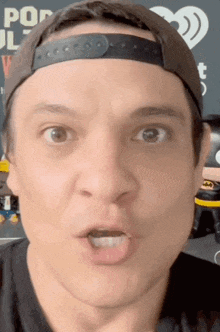 a close up of a man 's face wearing a baseball cap