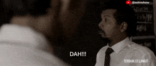 a man in a suit and tie says dah