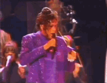 a group of people are dancing on a stage