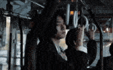 a man in a suit and tie is holding onto a handle on a bus