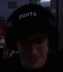 a person wearing a hat that says pants pants on it