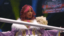 a woman in a purple and white outfit stands in front of a sign that says double nothing on it