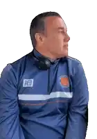 a man wearing a blue jacket with the word red on the back