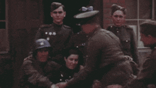 a group of soldiers are posing for a picture with one wearing a helmet that says u.s. army on it