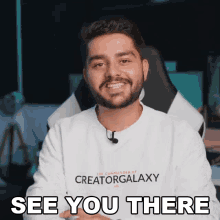 a man with a beard is wearing a white creatorgalaxy shirt