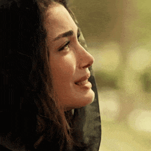 a close up of a woman 's face with tears coming out of her eyes