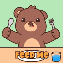 a teddy bear is sitting at a table holding a spoon and fork and says feed me