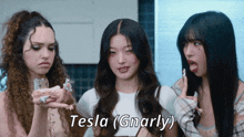 three women are standing next to each other with the words tesla ( gnarly ) written above them