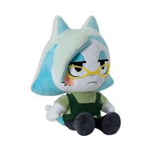a stuffed animal with glasses and blue hair is sitting down