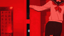 a girl in a sailor uniform is standing in front of a red wall with chinese writing on it