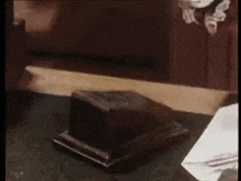 a person is sitting at a desk with a piece of paper on it