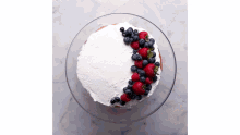 a cake with frosting and berries on it