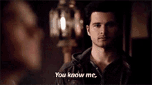a man in a leather jacket is standing next to a woman and saying `` you know me '' .
