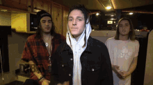 a group of young men are standing in a kitchen with the word debt on the bottom