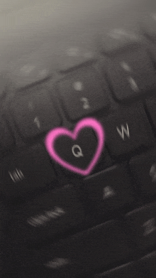 a keyboard with a heart on the q and w keys