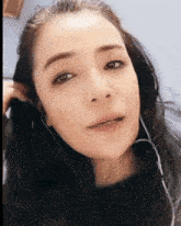 a close up of a woman 's face with headphones