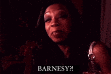 a close up of a woman 's face with her mouth open and the words barnesy written on it .