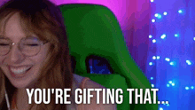 a woman sitting in a green chair with the words you 're gifting that behind her