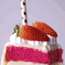 a slice of cake with strawberries on top and a polka dot straw