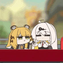 two cartoon characters are sitting next to each other and one of them has a m on her head