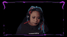 a woman wearing headphones and a t-shirt that says freedom