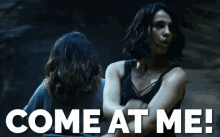 two women are standing next to each other with the words come at me written in white