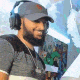 a man with a beard wearing headphones and a necklace with the word spiderman on it