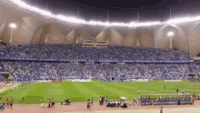 a soccer field with a banner that says " let 's fight together "