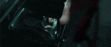 a woman in a red dress is swimming underwater in a dark pool .