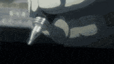 a close up of a person 's hand holding a pen in a dark room .