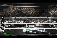 a video game is being played in a boxing ring with a robot laying on the floor