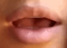 a close up of a person 's mouth with their mouth open and their tongue sticking out .