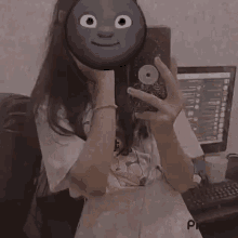 a girl taking a picture of herself with a smiley face on her phone