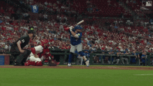 a baseball player swings his bat at a pitch while a catcher watches