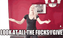 a woman is standing in front of a red wall with her arms outstretched and the words look at all the fucks i give above her
