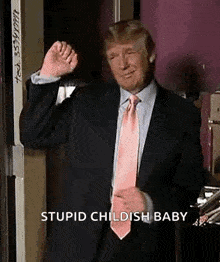 donald trump is wearing a suit and tie and making a funny face while standing in front of a door .