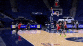 a basketball game is being played in an empty stadium with a car parked in the stands