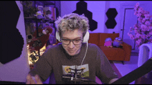 a man wearing glasses and headphones is sitting at a desk
