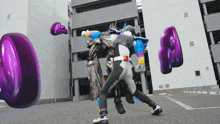 a person in a superhero costume is fighting another person