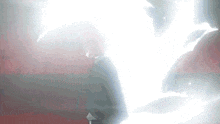 a person is standing in a dark room with a white light coming out of their chest .