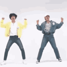 two men are dancing together in front of a white background .