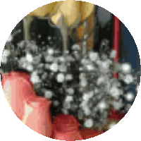 a blurred image of a table with candles and a wine glass