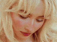 a close up of a woman 's face with blue eyes .